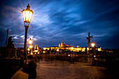 Charles bridge at dusk with view of the old town of Prague, Prague, Czech Republic