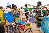 Women at the water well, pump in front of a school in the village of Machinga Peheriya, Malawi, Africa