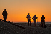 People watching the sunset on the beach, silhouettes, South Island, New Zealand