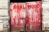 Old red faded double doors, coal shed, North Island, New Zealand