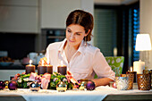Mid adult woman lighting candles on an Advent wreath, Styria, Austria