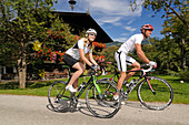 Couple on racing bikes, Schwaigerberg, Hopfgarten, Hohe Salve, Kitzbuehel Alps, Tyrol, Austria