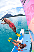 Man diving into the water to go snorkelling, Saint Regis Bora Bora Resort, Bora Bora, Society Islands, French Polynesia, Windward Islands, South Pacific