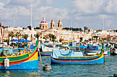 Luzzus, traditional Maltese fishing boats in the harbour, Marsaxlokk, Malta