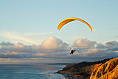 California, La Jolla, Paragliders flying over the coast. FOR EDITORIAL USE ONLY.