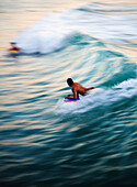 Hawaii, Oahu, Surfer riding a wave.