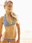Hawaii, Kauai, Kealia Beach, Surfer girl enjoying a day out.