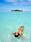 French Polynesia, Tahiti, Moorea, Woman floating in water.