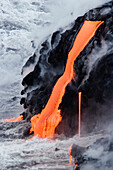 Hawaii, Big Island, near Kalapana, Pahoehoe lava flowing from Kilauea into Pacific Ocean.
