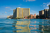 Hawaii, Oahu, Waikiki, Sheraton Waikiki and Royal Hawaiian Hotel seen from ocean with reflections.
