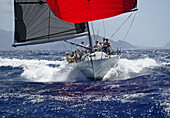Hawaii, Oahu, Waikiki Offshore Series 2005, sailboat on blue ocean, land in background.