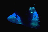 Hawaii, Lanai, Two divers with flashlights, pictured at the entrance to Second Cathedral.