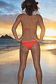 Hawaii, Oahu, Kailua, Lanikai, Young woman posing on beach.