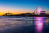 Santa Monica Pier at twilight with the amusement park lit up. A ferris wheel. California., Santa Monica Pier Twilight
