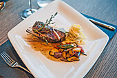 Lamb chop with zucchini, aubergines, peppers and noodles, Restaurant