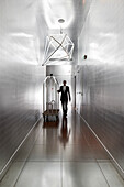 Hotel clerk in the silver hallway with walls covered in aluminium, Hotel La Maison Champs-Elysees, designed by Martin Margiela, Paris, France