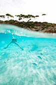 Girl diving in bay Cala S Amonia, Mallorca, Balearic Islands, Spain