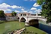 The city skyline with churches and a bridge over the Tiber River in Rome, Italy