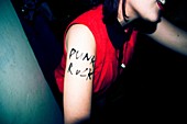 Girl with punk rock written on his arm. London
