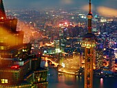 An aerial view overlooking Shanghai, China´s financial district with prominent view of the Oriental Pearl Tower and the Jin Mao Tower at night