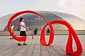 Women practice ribbon dancing at the National Centre for Performing Arts park in Beijing, China