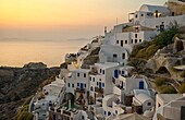 Sunset of white buildingsin Oia in Santorini Greece in Greek Islands