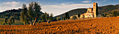 Sunrise above the Benedictine monastery Abbey de Sant’ Antimo in the Tuscan countryside south of Siena, Val d'Orsia, Tuscany, Italy