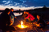 Family at campfire, Werbeliner See, Saxony, Germany