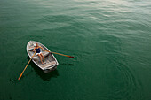 Young woman in a rowboat on lake Starnberg, Bavaria, Germany