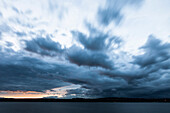 Lake Starnberg with storm clouds at dusk, Bavaria, Germany