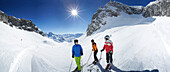 Three skiers on slope, Zurs, Lech, Vorarlberg, Austria