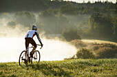 Man cyclocross touring in autumn, Degerndorf, Munsing, Bavaria, Germany