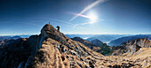 Mountain hiker ascending summit, Hochiss, Rofan, Tyrol, Austria