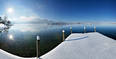 Snow-covered jetty at lake Kochel, Upper Bavaria, Germany