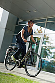 Woman riding an e-bike, Munich, Bavaria, Germany