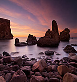 Silhouette of rock formations in the sea at dawn, Reykjanes, Iceland