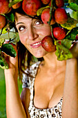 Young woman in an apple tree, Styria, Austria