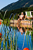 Young woman at a swimming pool of a hotel, Fladnitz an der Teichalm, Styria, Austria