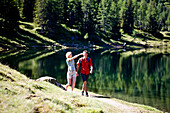 Couple hiking along lake Duisitzkar, Styria, Austria