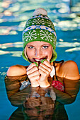 Young woman wearing a wolly hat in a swimming pool, Styria, Austria