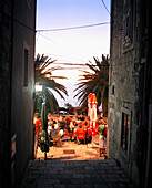 CROATIA, Korcula, Dalmatian Coast, people sitting at an outdoor restaurant in Korcula at night.