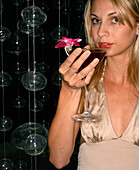 USA, Nevada, Las Vegas, young woman drinking cocktail, close-up, portrait at Mix Restaurant
