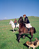 SPAIN, Andalusia, Tarifa, mature man and woman riding horse on hill