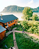 USA, Alaska, Redoubt Bay Lodge, man walking with fly fishing rod, elevated view