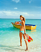 ARUBA, young woman in bikini walking into water with snorkel and mask, Surfside Beach, Oranjestad