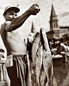 BRAZIL, Belem, South America, man holding fish, Ver-O-Peso market