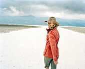 USA, California, Death Valley, woman walking at Badwater Salt Flats