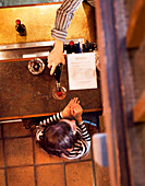 USA, California, Sonoma, a woman is served a glass of red wine at the bar in the tasting room, Buena Vista Winery