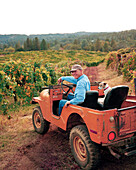 USA, California, Greg Boeger and his dog Kirby check on the vines at the Boeger Winery in Placerville, Gold Country
