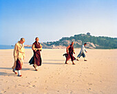 CHINA, monks walking on Thousand Steps beach, Putuoshan